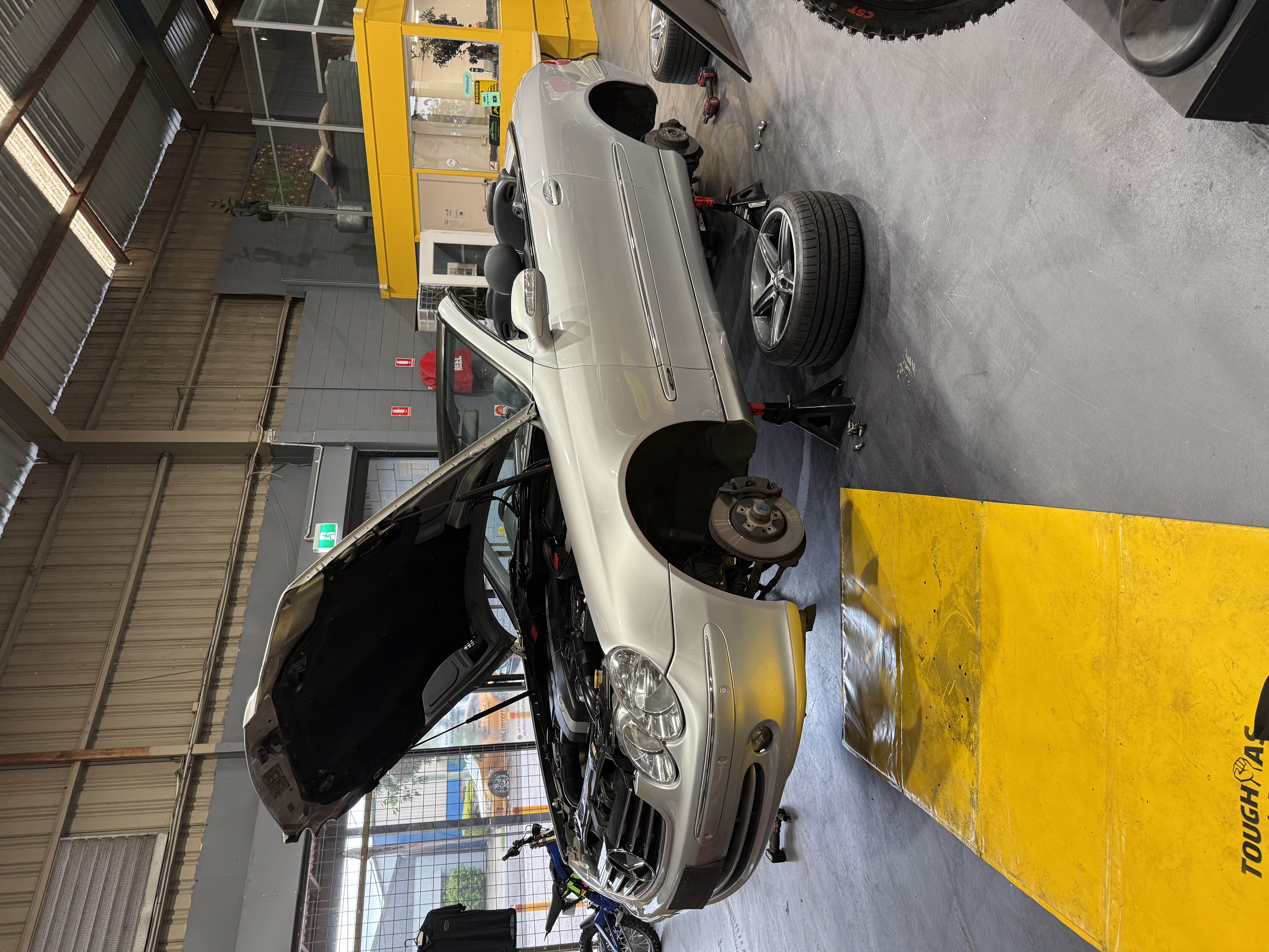 Silver sedan on jack stands during a full mobile service at a Lake Macquarie home - Meek Mobile, Lake Macquarie